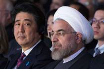 FILE - In this Jan. 22, 2014 file photo, Japanese Prime Minister Shinzo Abe, left, and Iranian ...