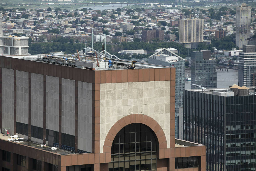 Law enforcement personnel work on the roof of the AXA Equitable building, Tuesday, June 11, 201 ...