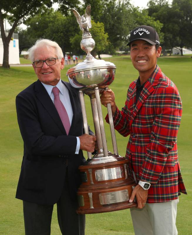 Charles Schwab and Kevin Na pose with the Leonard Trophy after Na won the Charles Schwab Challe ...