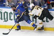 Boston Bruins left wing Jake DeBrusk (74) tries to stop St. Louis Blues defenseman Robert Bortu ...