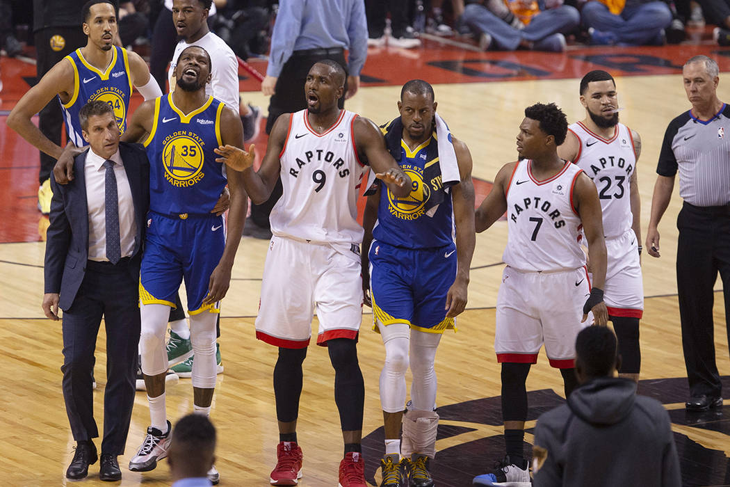 Golden State Warriors' Kevin Durant (35) walks off the court after sustaining an injury as Toro ...