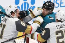 Golden Knights right wing Mark Stone (61) fights San Jose Sharks right wing Timo Meier (28) in ...