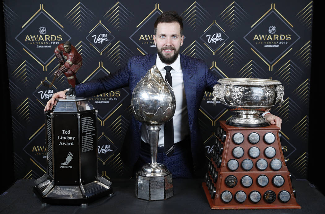 Tampa Bay Lightning's Nikita Kucherov poses with, from left, the Ted Lindsay Award, Hart Memori ...