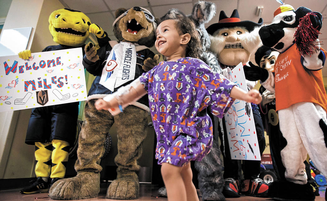 Camila Silva, 2, dances with a group of Las Vegas-based mascots during a welcome event for Mile ...