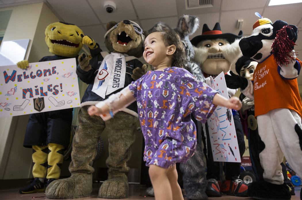 Camila Silva, 2, dances with a group of Las Vegas-based mascots during a welcome event for Mile ...