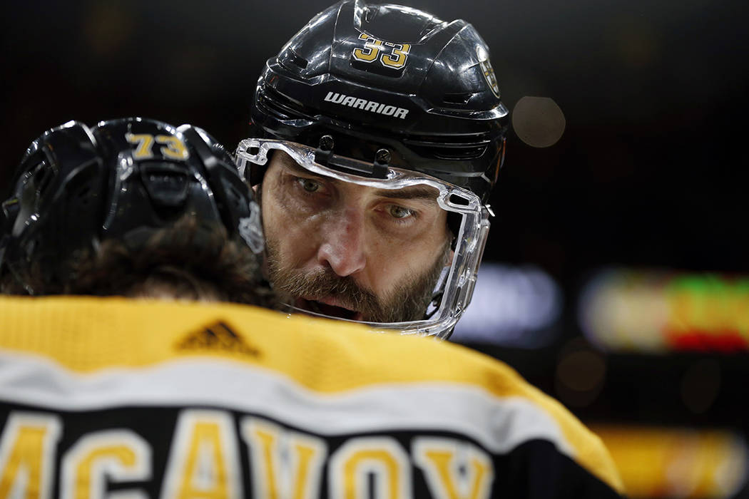 Boston Bruins' Zdeno Chara, rear, of Slovakia, speaks to Charlie McAvoy during the first period ...
