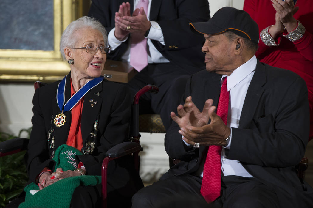 FILE - In a Nov. 24, 2015 file photo, Willie Mays, right, applauds NASA mathematician Katherine ...