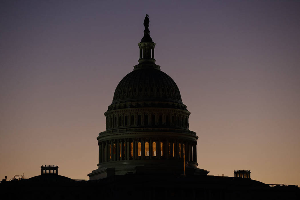 The U.S. Capitol Building Dome is seen before the sun rises in Washington, Tuesday, Dec. 18, 20 ...