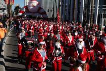 People run in the 14th annual Las Vegas Great Santa Run in downtown Las Vegas, Saturday, Dec. 1 ...