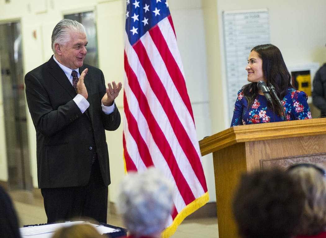 Gov. Steve Sisolak, left, claps as Assemblywoman Sandra Jauregui, D-Las Vegas, speaks before Si ...