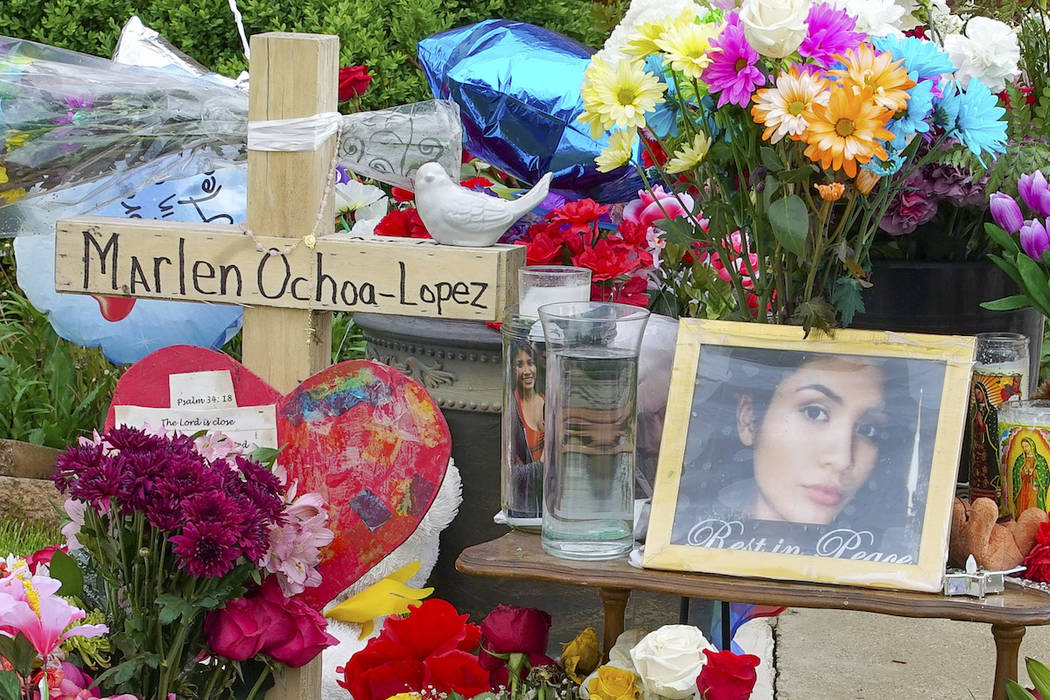 A memorial of flowers, balloons, a cross and photo of victim Marlen Ochoa-Lopez, are displayed ...