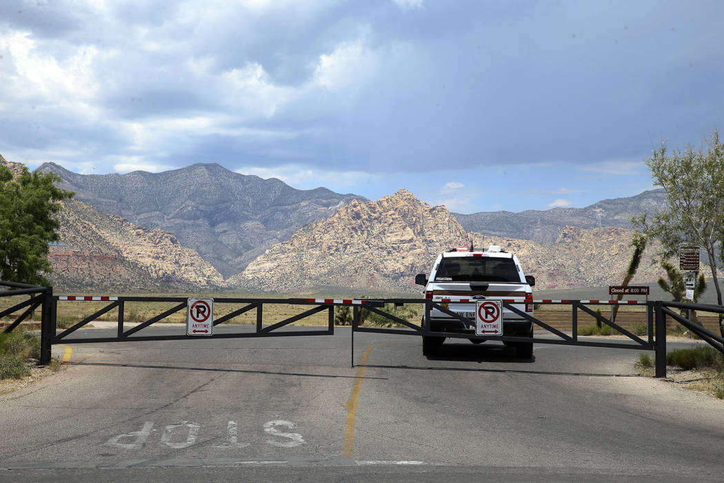 A Bureau of Land Management ranger blocks the entrance to the Red Rock Overlook on U.S. Highway ...