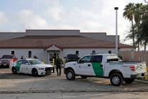 In a Saturday, June 23, 2018, file photo, a U.S. Border Patrol Agent walks between vehicles out ...