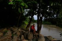 A local resident relaxes beside the Suchiate river in Frontera Hidalgo, Mexico, on the border w ...