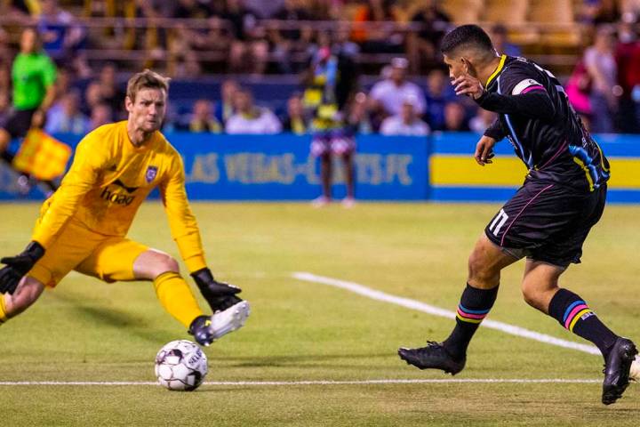 Las Vegas Lights FC forward Irvin Parra (11, right) sends a shot towards the net past Orange Co ...