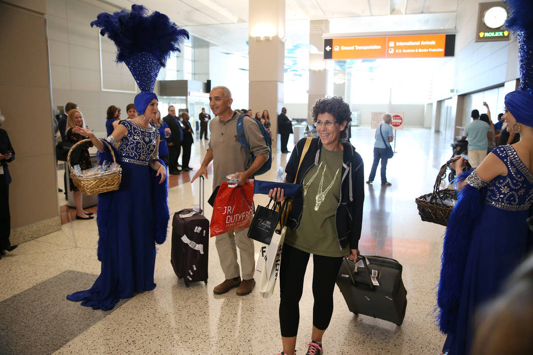 Igal Cohen, left, and his wife Noga, arrive to McCarran International Airport in Las Vegas, Fri ...