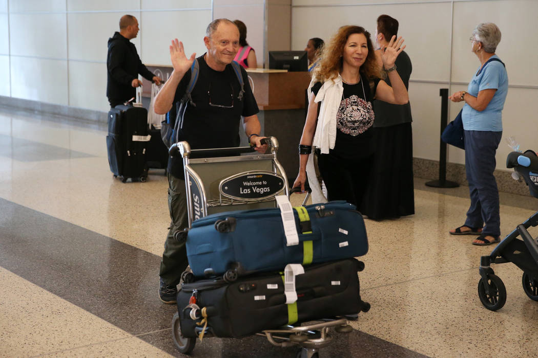 Israel Lavi, left, and his wife Ruth, wave as they arrive to McCarran International Airport in ...