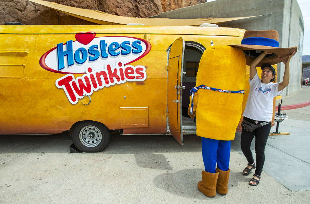 Twinkie the Kid has their hat removed by Katie Lewis while on a stop at the Hoover Dam in celeb ...