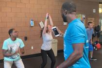 Courtney Woods encourages teens performing jumping jacks during his Power Hour class at the Sky ...