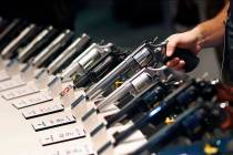 In this Jan. 19, 2016 file photo, handguns are displayed at the Smith & Wesson booth at the Sho ...