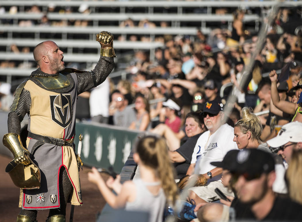 Lee Orchard, aka The Golden Knight, left, fires up the crowd during the Battle For Vegas Charit ...