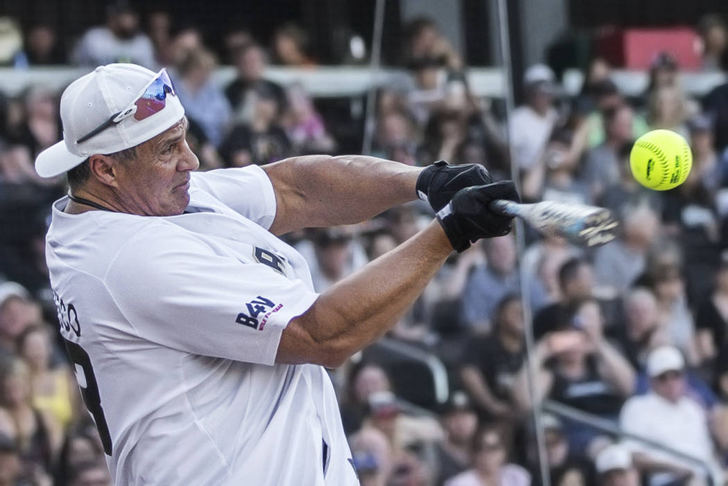 Former Major League Baseball player Jose Canseco takes a swing during the home run derby at the ...