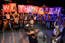 LAS VEGAS, NEVADA - JUNE 14: Drake carries the Larry O'Brien NBA Championship Trophy as he cele ...