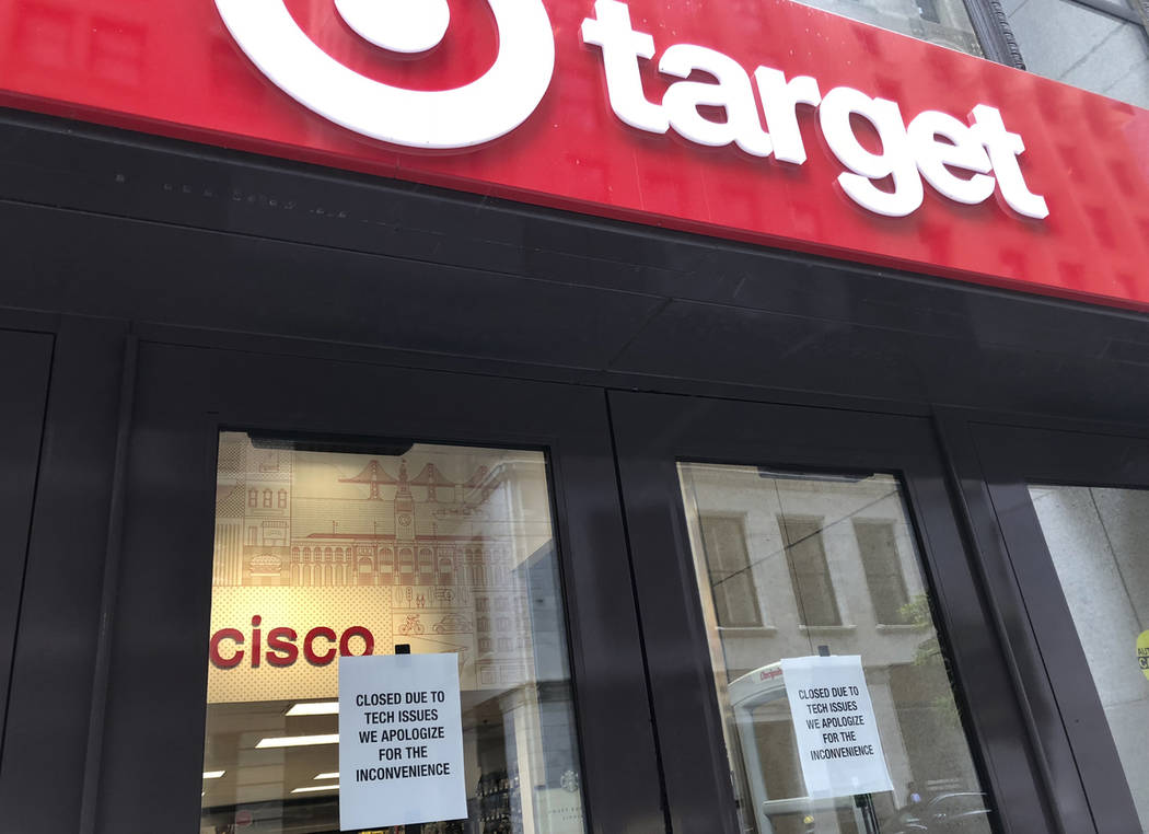 A sign is posted explaining a technical glitch at a Target store in San Francisco on Saturday, ...