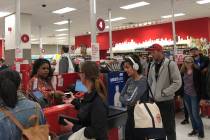 Customers wait on a long check out line at a Target store in San Francisco on Saturday, June 15 ...