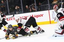 Golden Knights center William Karlsson (71) slips on the ice while trying to get the puck in ag ...