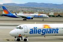File - In this May 9, 2013, file photo, two Allegiant Air jets taxi at McCarran International A ...