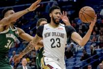 New Orleans Pelicans forward Anthony Davis takes an outlet pass against Milwaukee Bucks forward ...