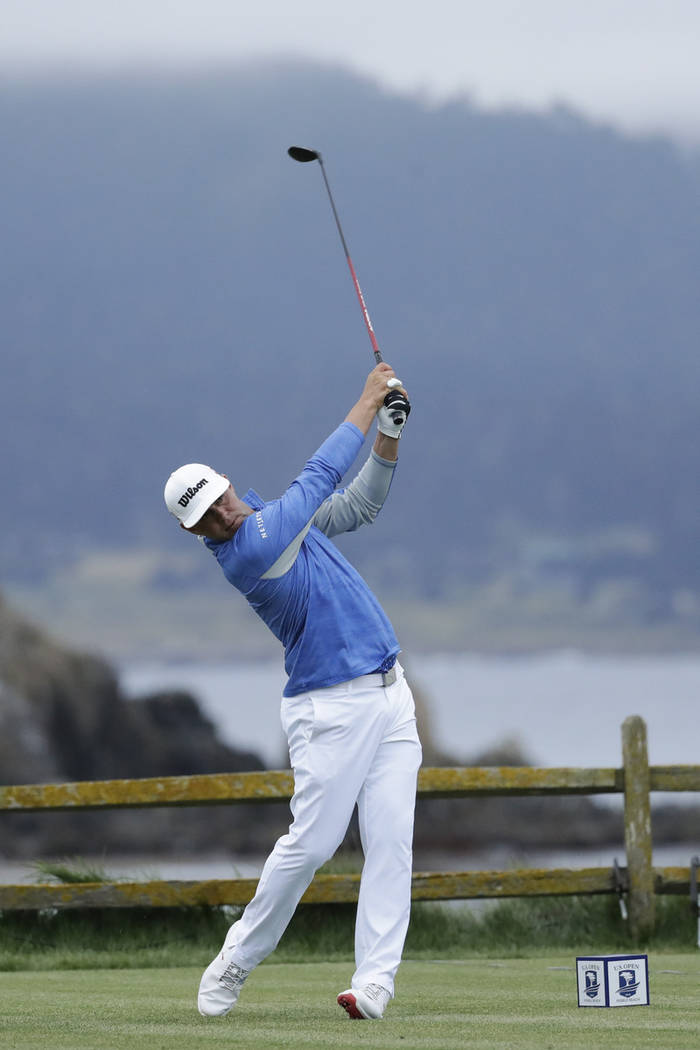 Gary Woodland watches his tee shot on the 18th hole during the third round of the U.S. Open gol ...