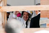 Pope Francis wears a safety helmet as he arrives to visit the earthquake damaged Cathedral of C ...