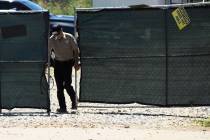A security guard closes a gate at the construction site of a new clinic that is being built by ...