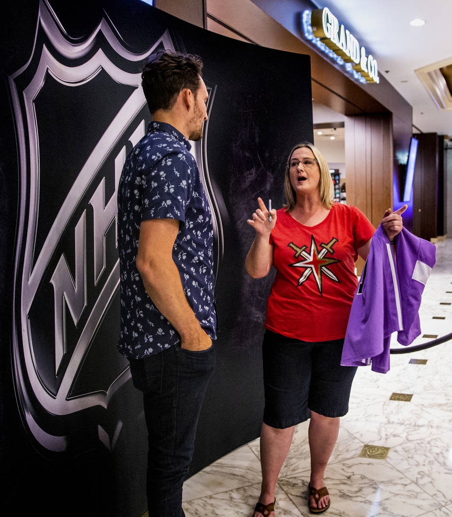 Golden Knights player Mark Stone is told a story of their past meeting by Kristie McWhorter of ...