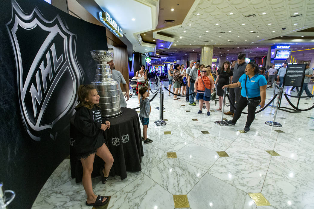 Fans wait in line to strike a pose with the Stanley Cup, the most recognizable and revered trop ...