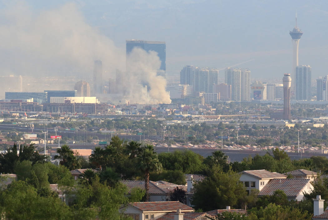 Heavy smoke is seen as Clark County and Las Vegas fire crews battle a blaze at The Park at 3900 ...