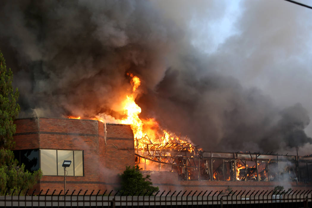 An early morning fire engulfs a business complex near Paradise Road and East Twain Avenue in La ...