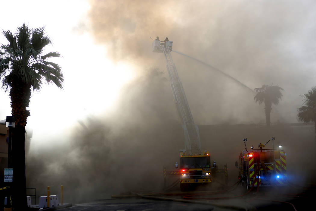 Firefighters work to gain control over a business complex fire near Paradise Road and East Twai ...
