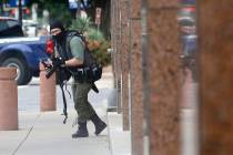 An armed shooter stands near the Earle Cabell Federal Building Monday, June 17, 2019, in downto ...