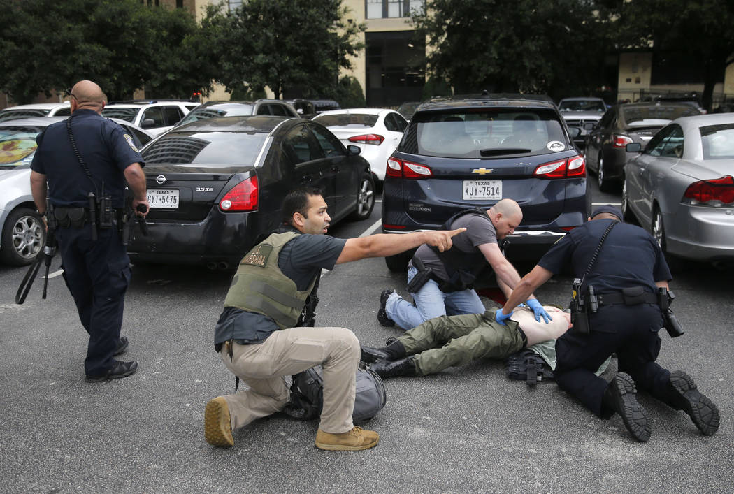 Members of the Department of Homeland Security and the U.S. Marshal's Service tend to the downe ...