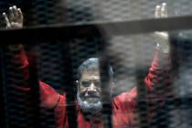 Former Egyptian President Mohammed Morsi, wearing a red jumpsuit that designates he has been se ...