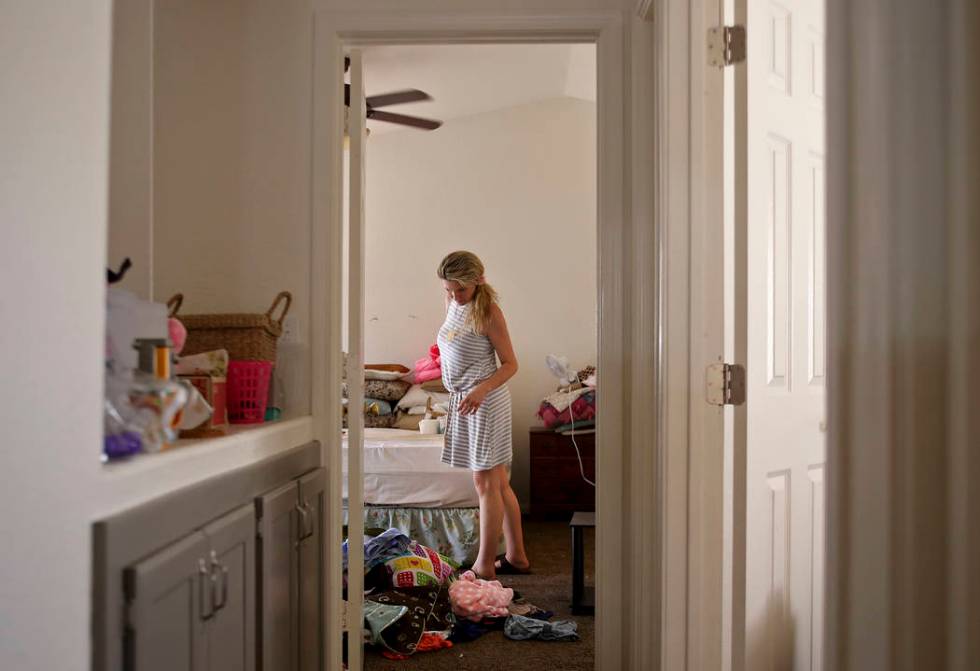 Kari Monson packs her belongings after being evicted for failure to pay rent in Las Vegas, Mond ...