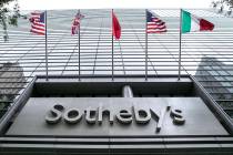 Flags fly on the front of Sotheby's auction house, in New York, Monday, June 17, 2019. BidFair ...