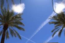 A water mister and multiple jet streams are seen on a hot day in Henderson. (Bizuayehu Tesfaye/ ...