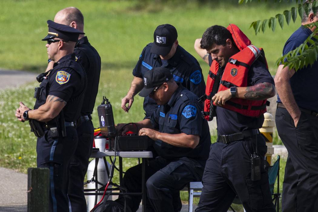 Police search the Kalamazoo River near Verburg Park, Tuesday, June 18, 2019, after finding the ...