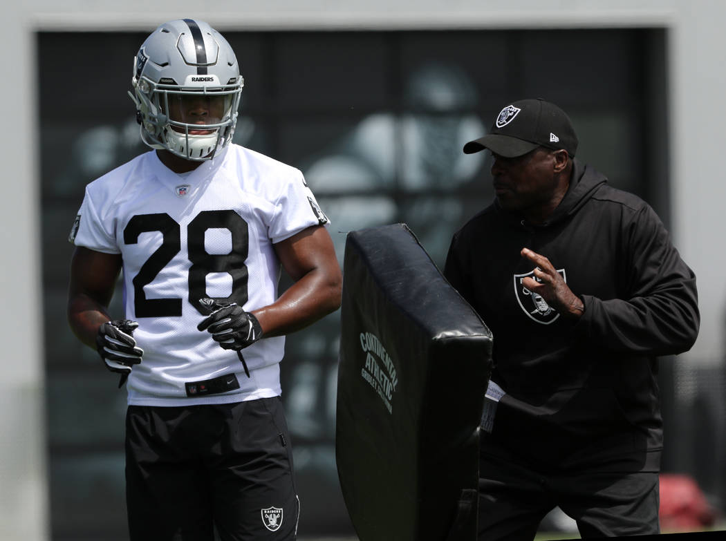 Oakland Raiders running back Josh Jacobs (28) works with running back coach Kirby Wilson during ...