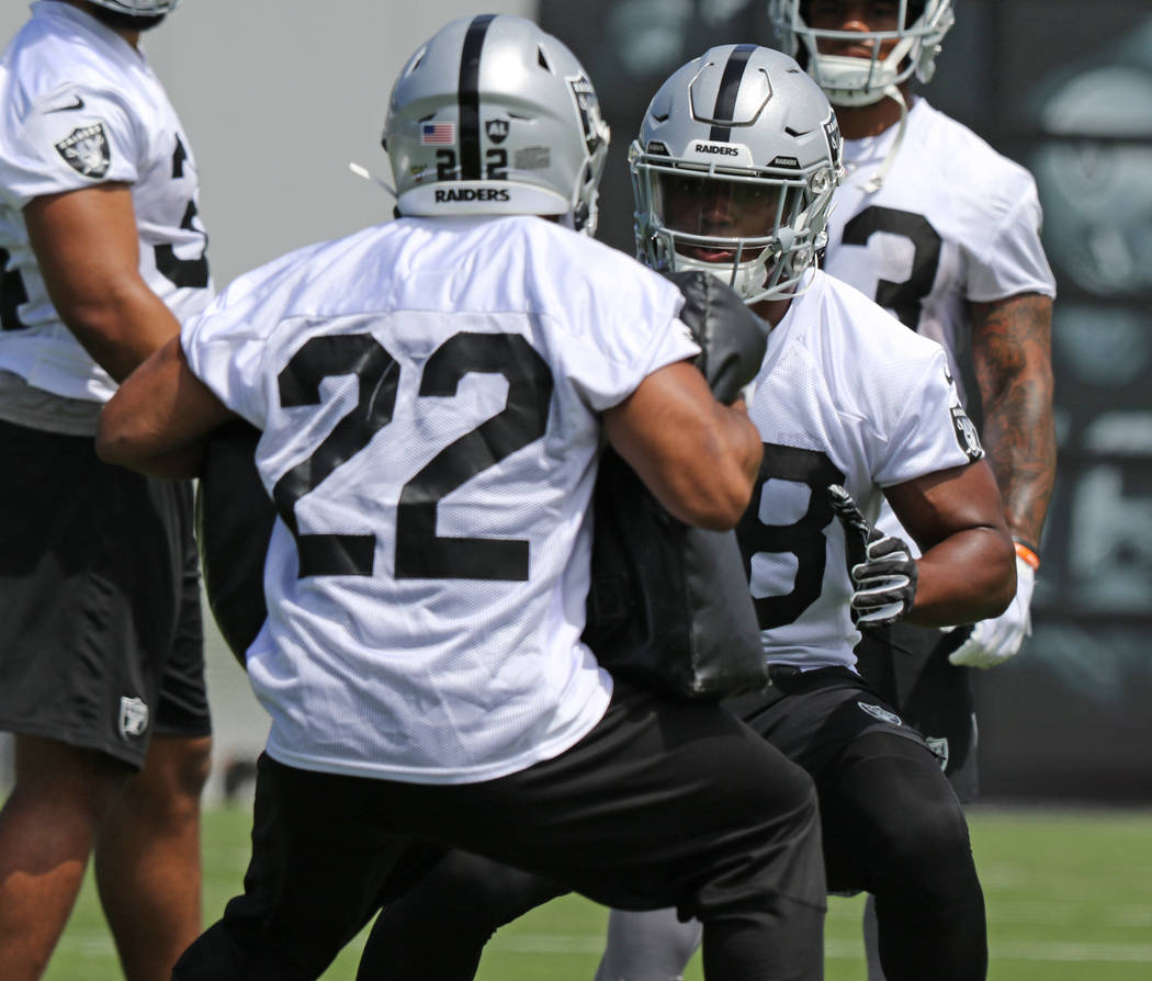 Oakland Raiders running back Josh Jacobs (28) works with running back Doug Martin (22) during ...