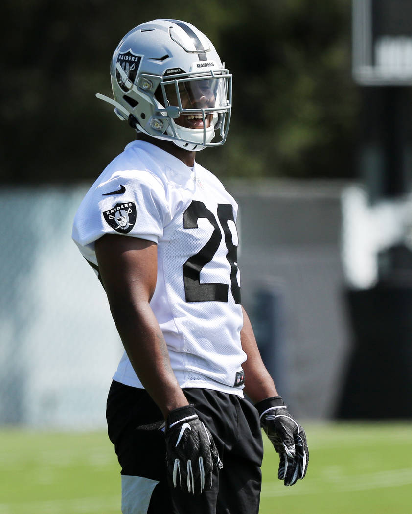 Oakland Raiders running back Josh Jacobs (28) smiles while watching drills during an offseason ...